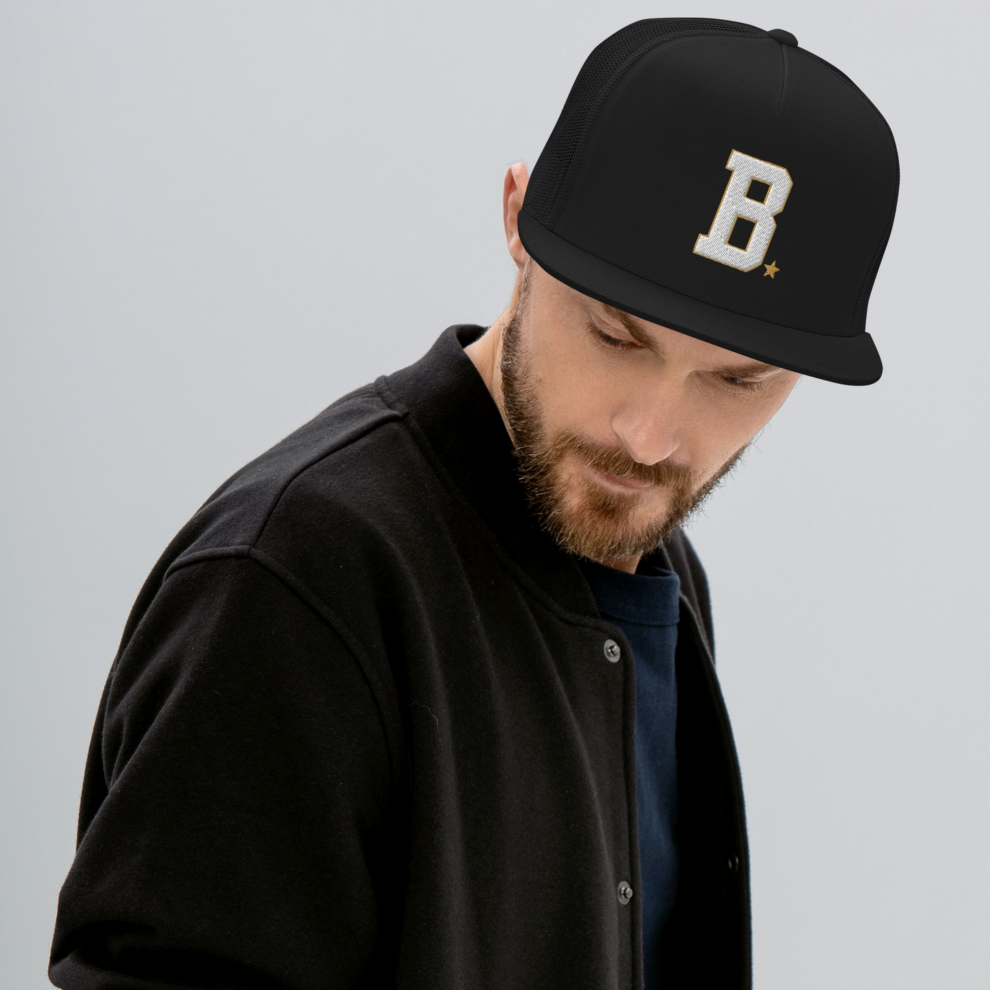Athlete wearing a black cap with B logo on a gray background