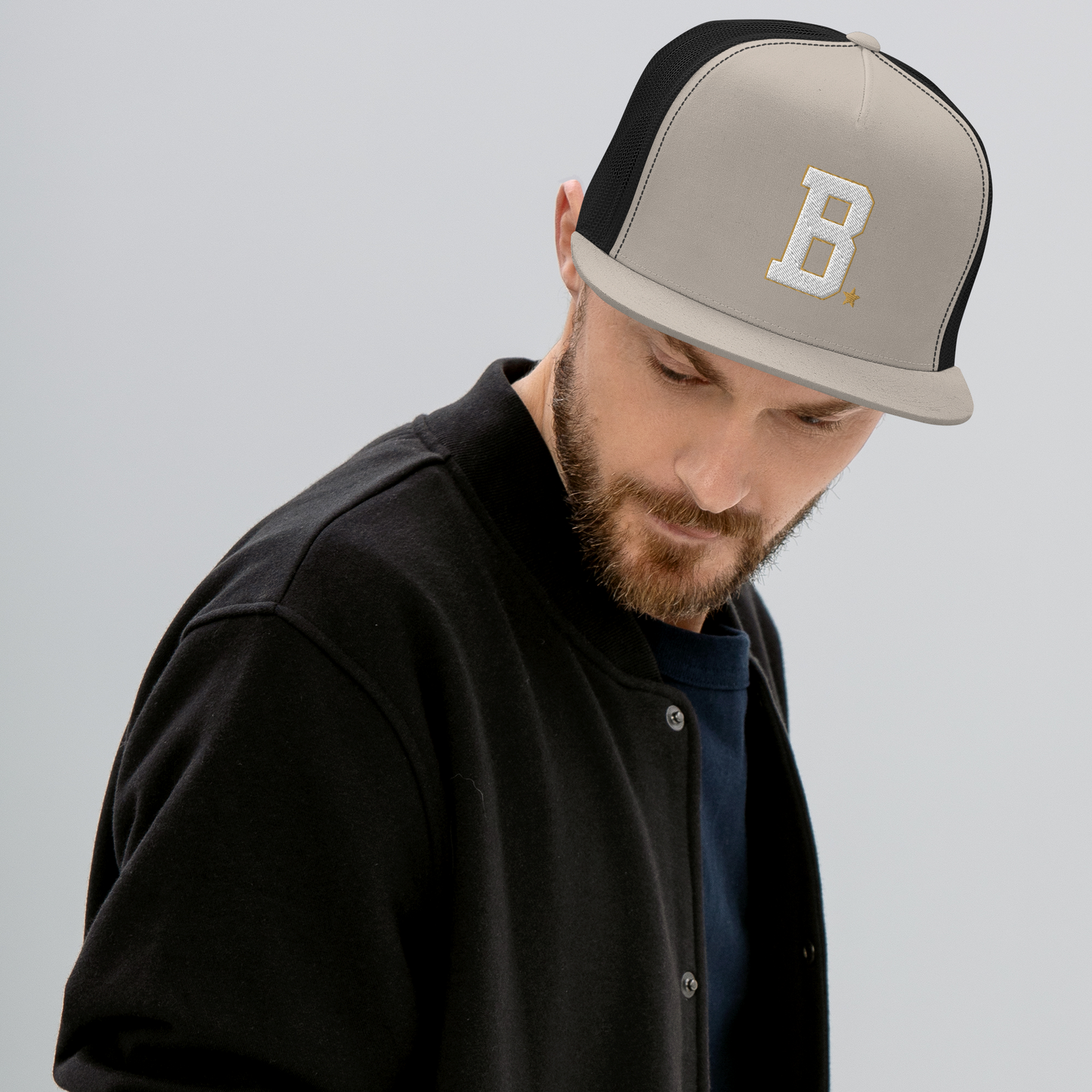 Athlete wearing a bone and black cap with B logo on a light gray background