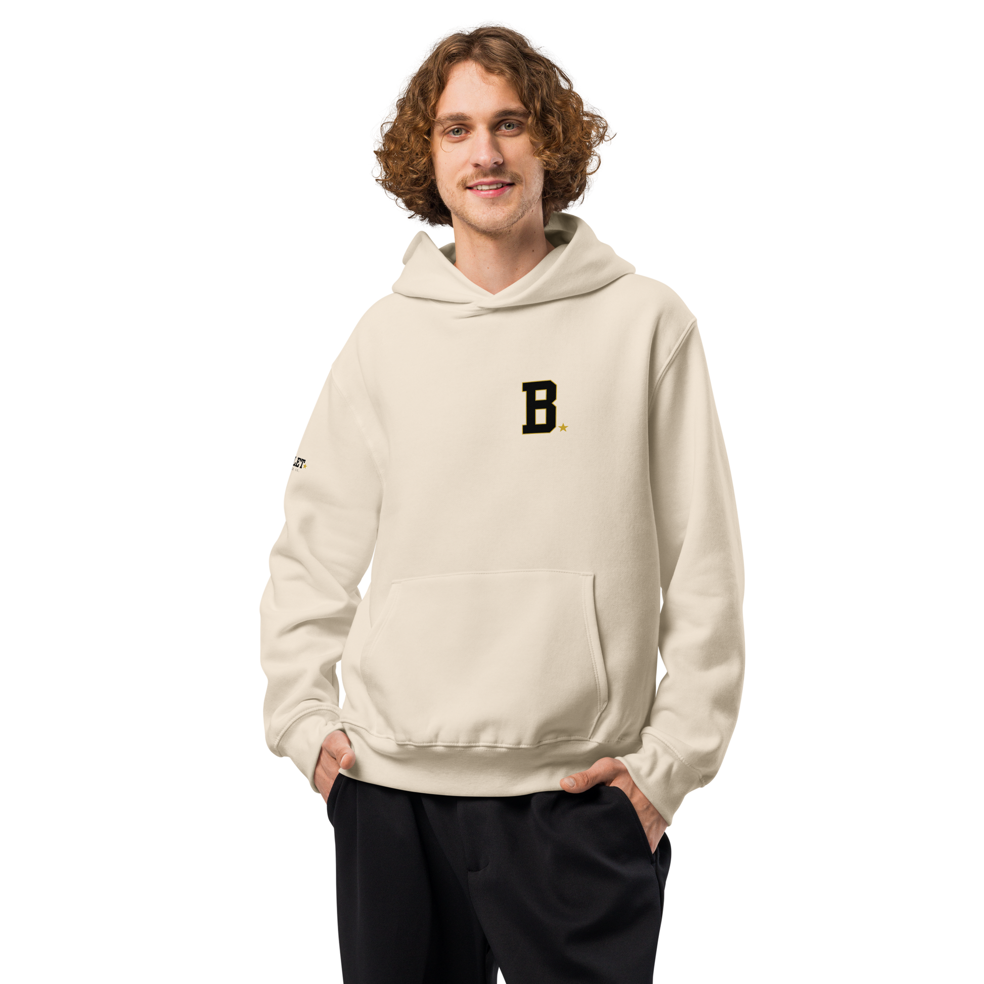 Athlete wearing bone Field Hoodie with minimalist varsity B chest logo