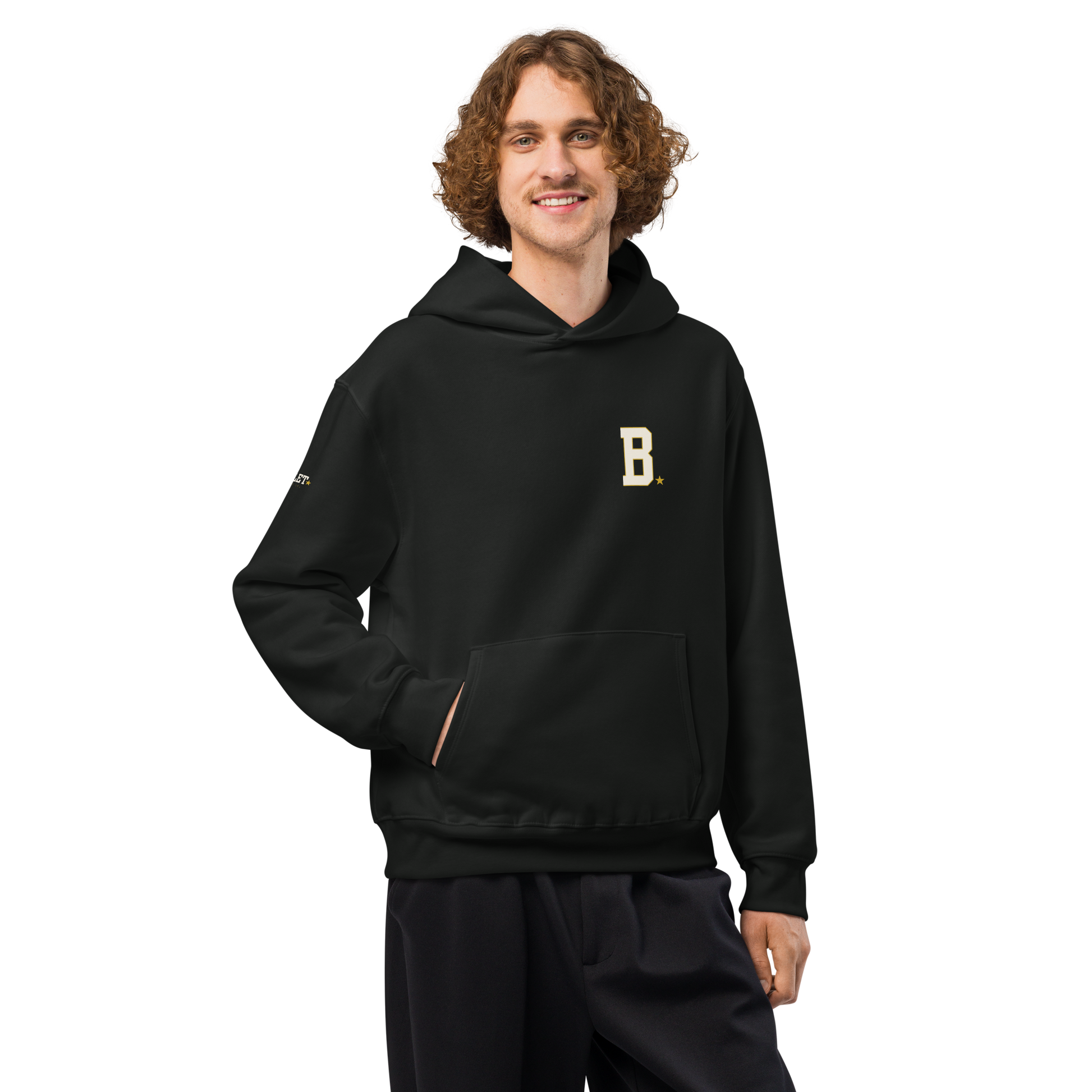 Athlete wearing black Field Hoodie with minimalist varsity B chest logo